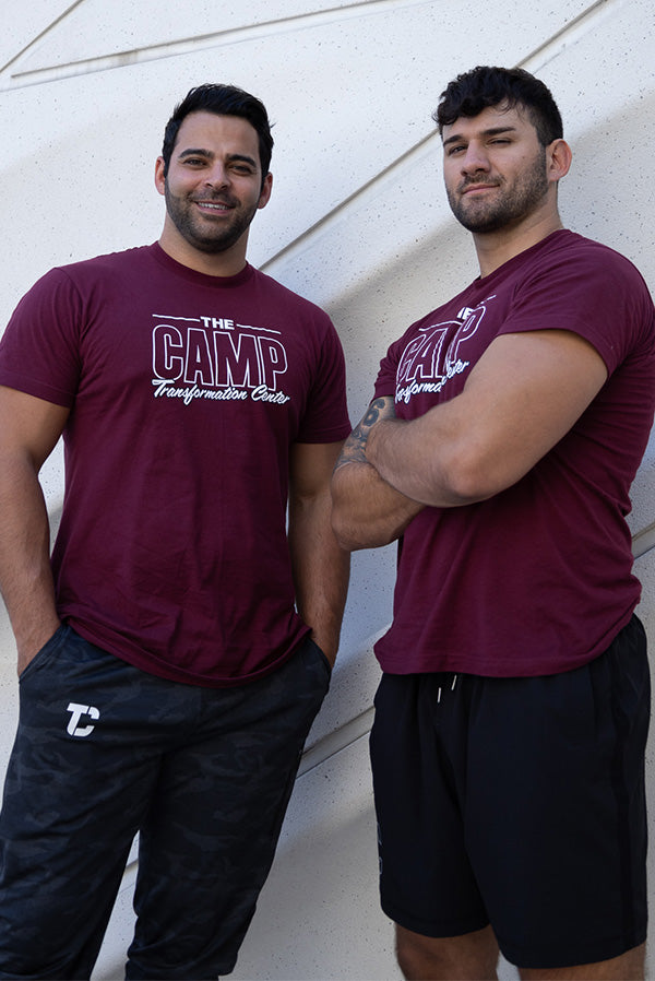Photograph of two models wearing The CAMP Transformation Center t-shirts