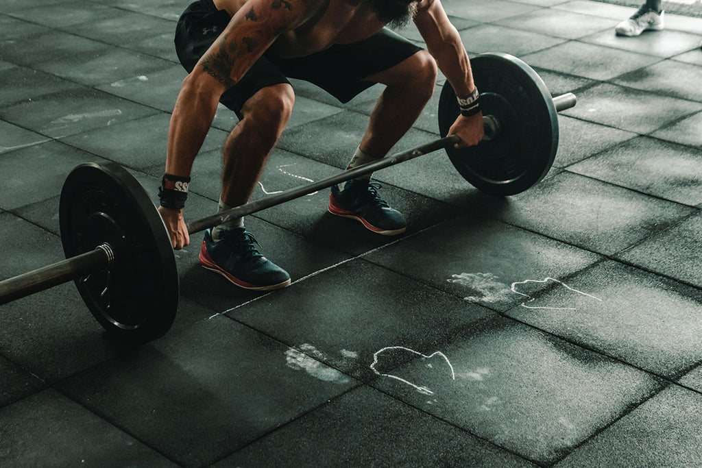 Photograph of a weightlifter set to lift a barbell